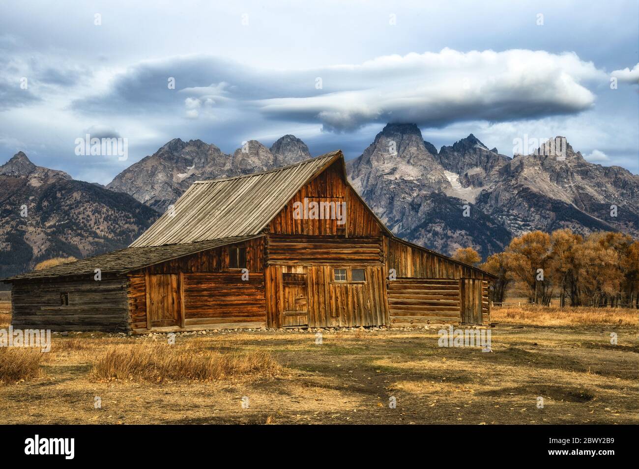 The T.A. Moulton Barn with clouds over the Teton Mountain Range in the background Stock Photo