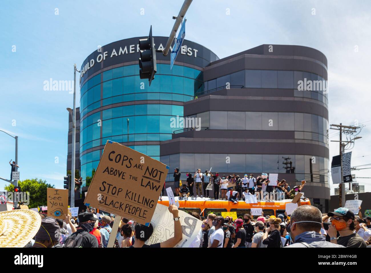 Protesters on top of a bus at a Black Lives Matter protest over the killing of George Floyd: Fairfax District, Los Angeles, CA, USA, May 30, 2020 Stock Photo