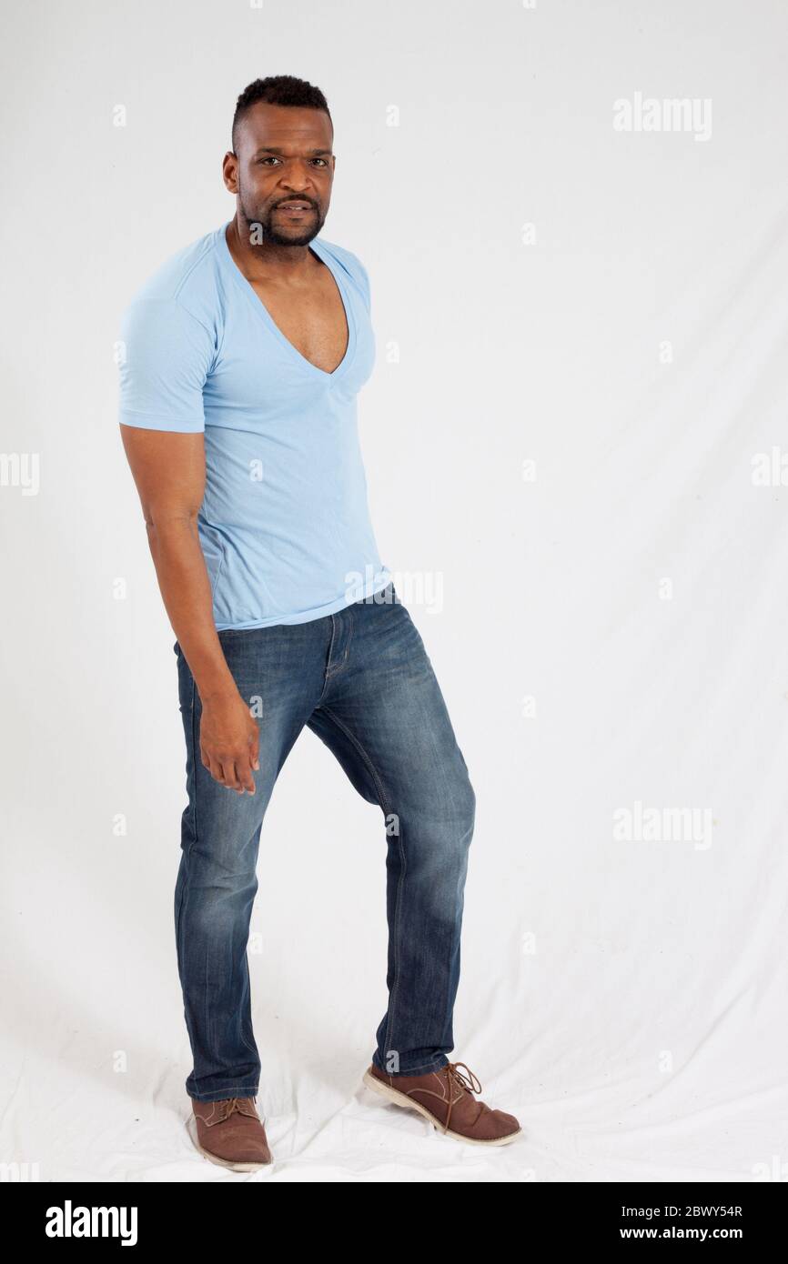 Handsome Black man in a blue shirt looking thoughtful Stock Photo