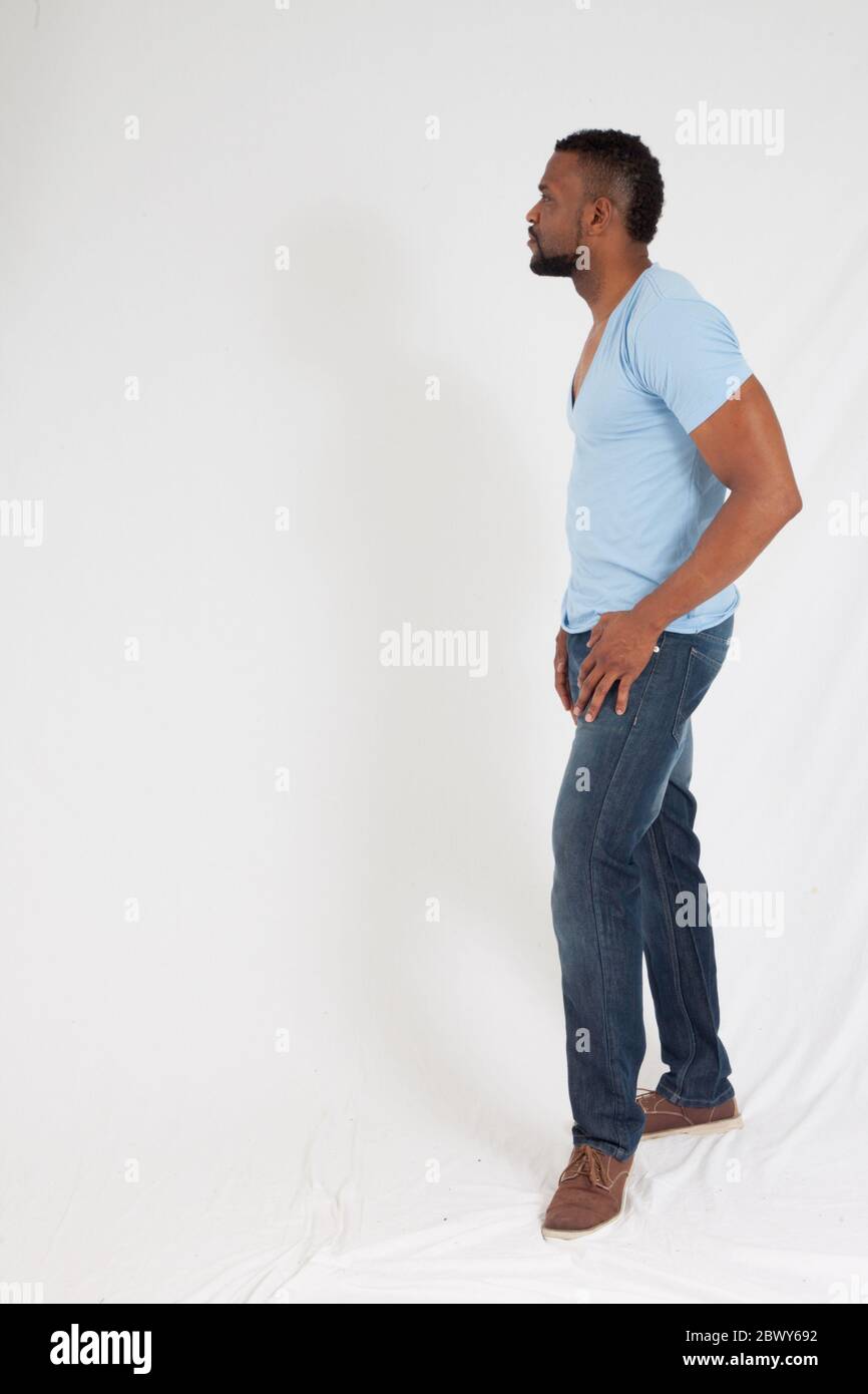 Handsome Black man in a blue shirt looking thoughtful Stock Photo