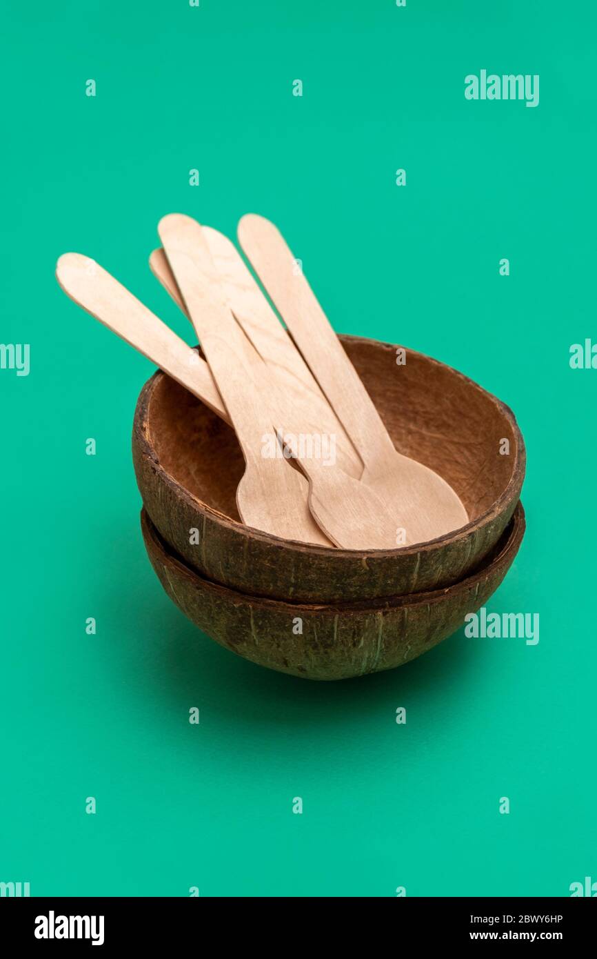 Compostable biodegradable disposable cutlery on green background Stock Photo