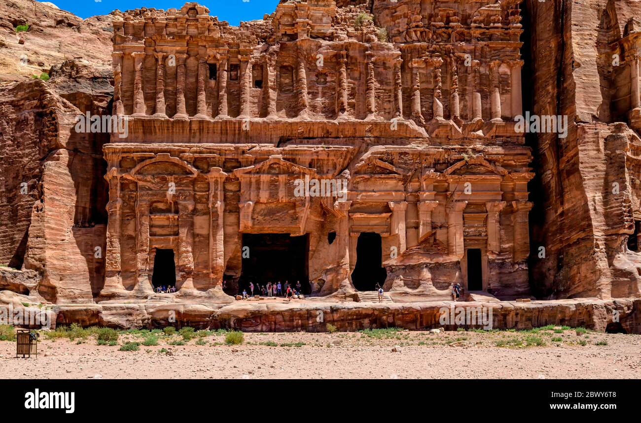 The ornately carved sandstone facade surrounding the entrance of the Palace Tomb in the Royal Tomb complex of Petra Stock Photo