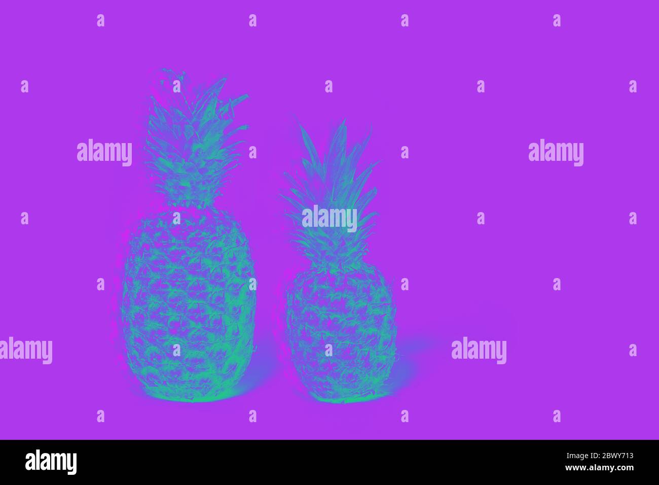 Two pineapples isolated on a lilas background. glitch effect Stock Photo