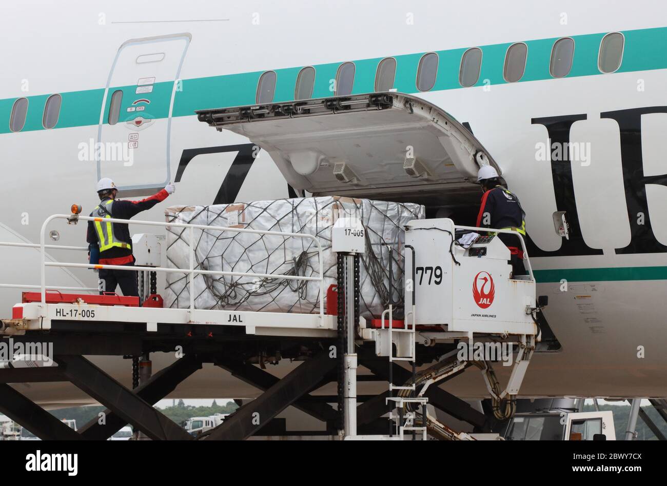 Narita, Japan. 3rd June, 2020. Freight staffs load machinery parts to a Boeing 787 plane of Japan Airlines' (JAL) new budget airline ZipAir Tokyo as the airline launches the first revenue flight at the Narita international airport in Narita, suburban Tokyo on Wednesday, June 3, 2020. Japan's first long distance low cost carrier ZipAir scheduled to launch the passenger flight service last month but delayed their services since outbreak of the new coronavirus. Credit: Yoshio Tsunoda/AFLO/Alamy Live News Stock Photo
