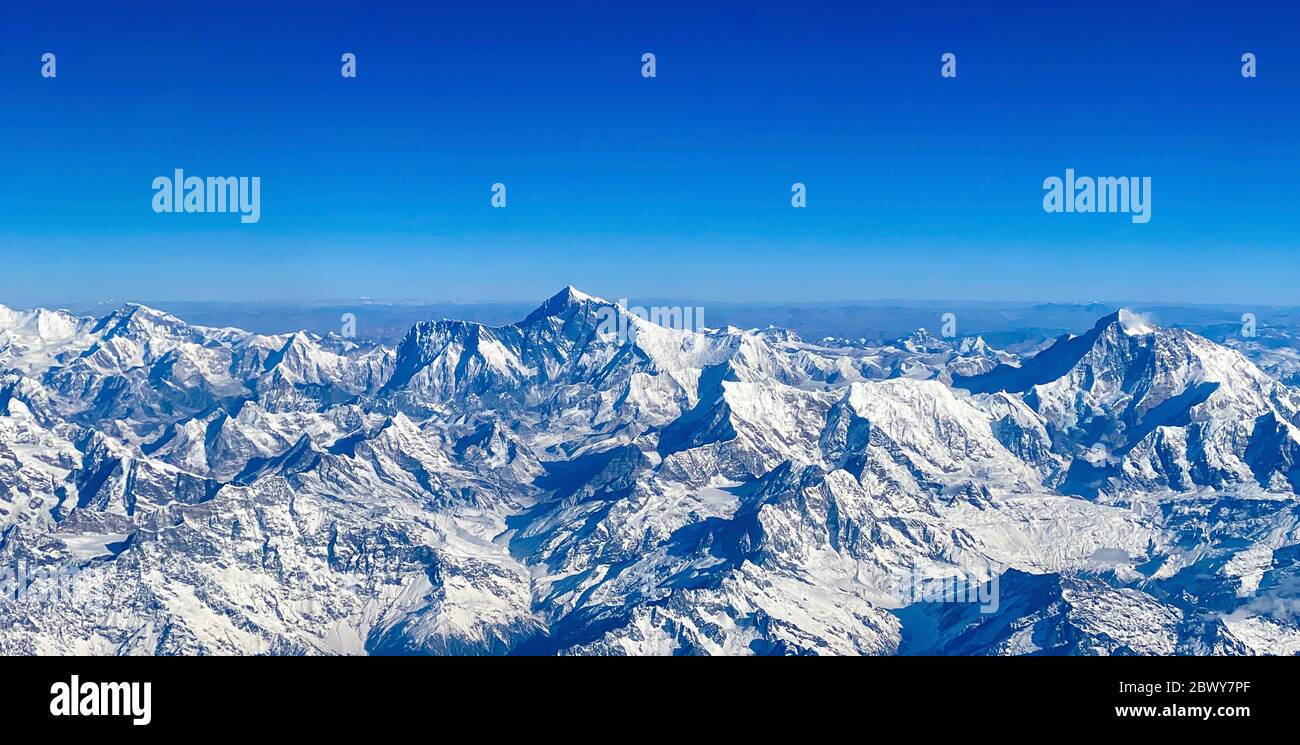 Aerial view of Mt. Everest (center) and Himalaya Range on flight from
