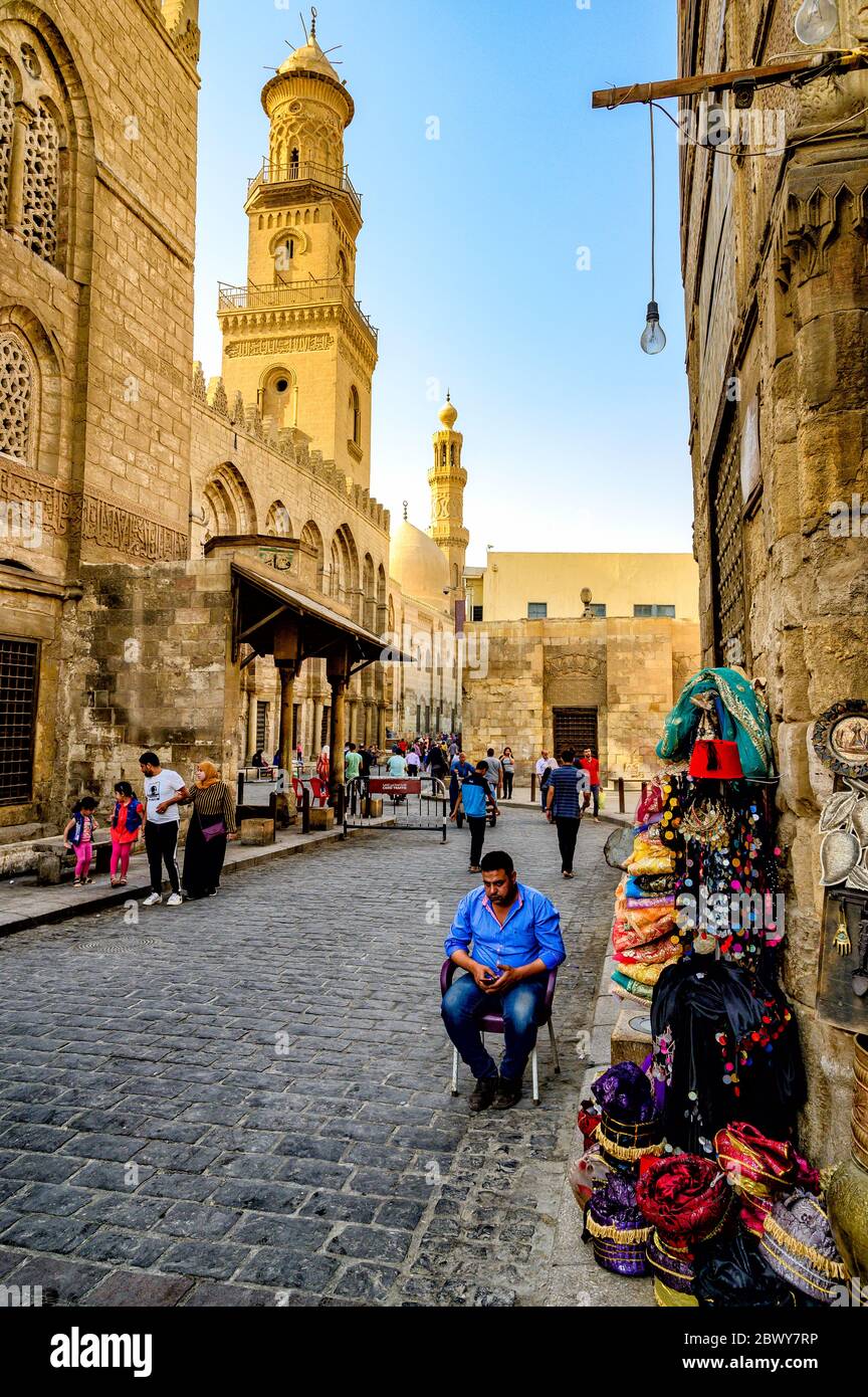 The minaret of the Qalawun complex rises over Al-Muizz street in the heart of Islamic Cairo Stock Photo