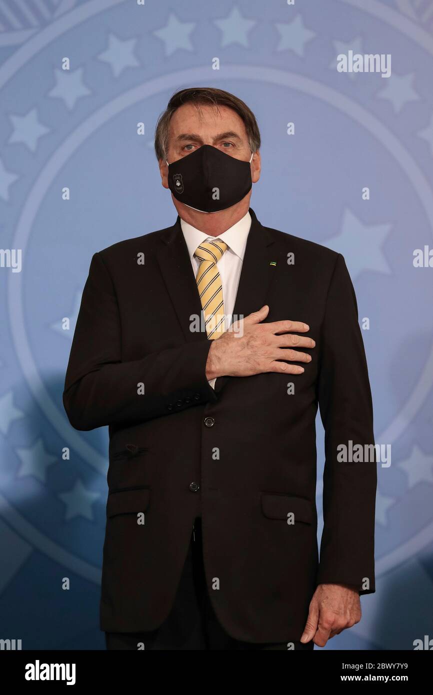 Brazilian President Jair Bolsonaro wears a PPE mask amid the COVID-19 pandemic, during an event promoting a government campaign against domestic violence at Planalto presidential palace May 15, 2020 in Brasilia, Brazil. Stock Photo