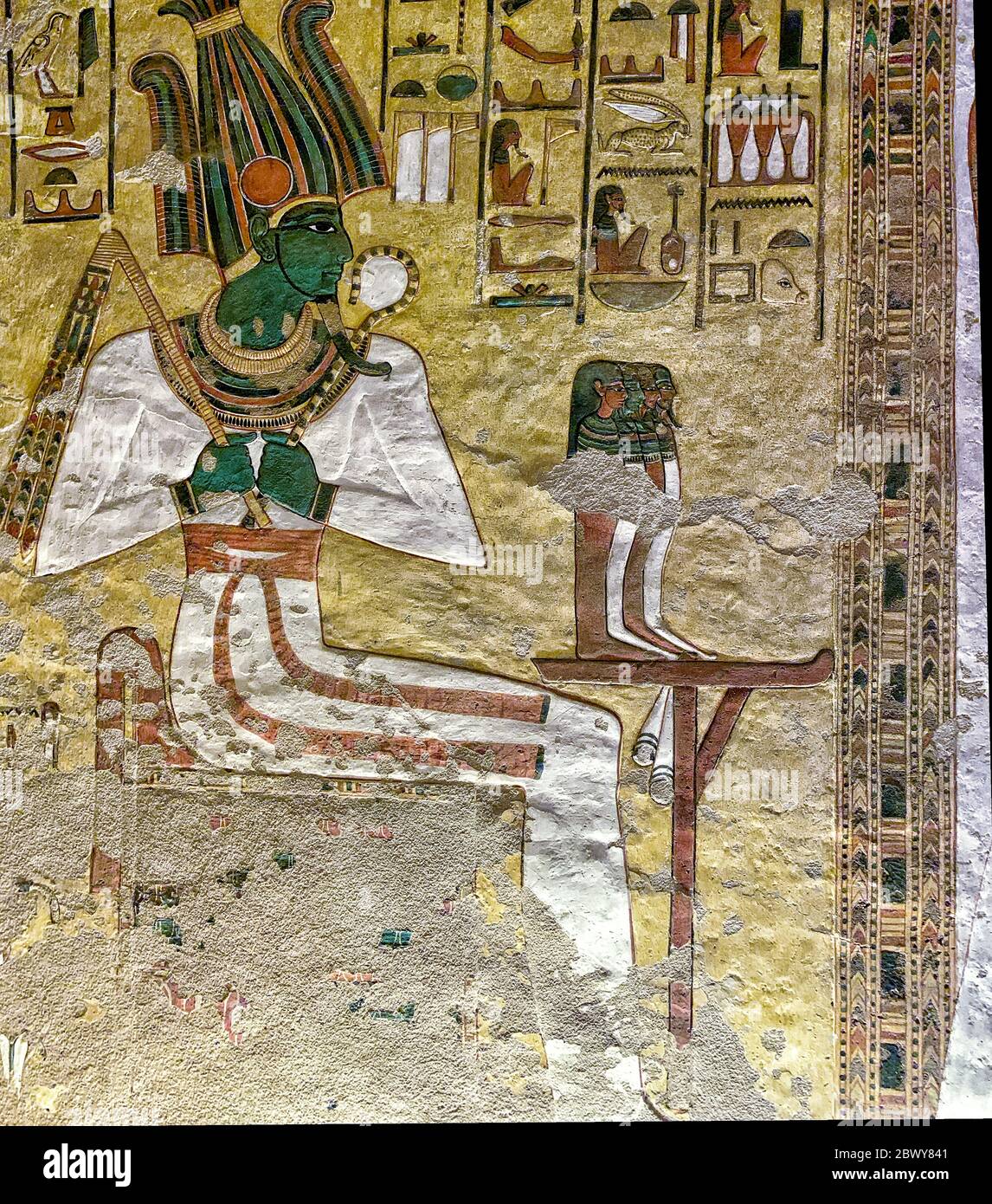 The mummiform god Osiris enthroned on the usual throne. Before him, on a stand, are the four sons of Horus Stock Photo