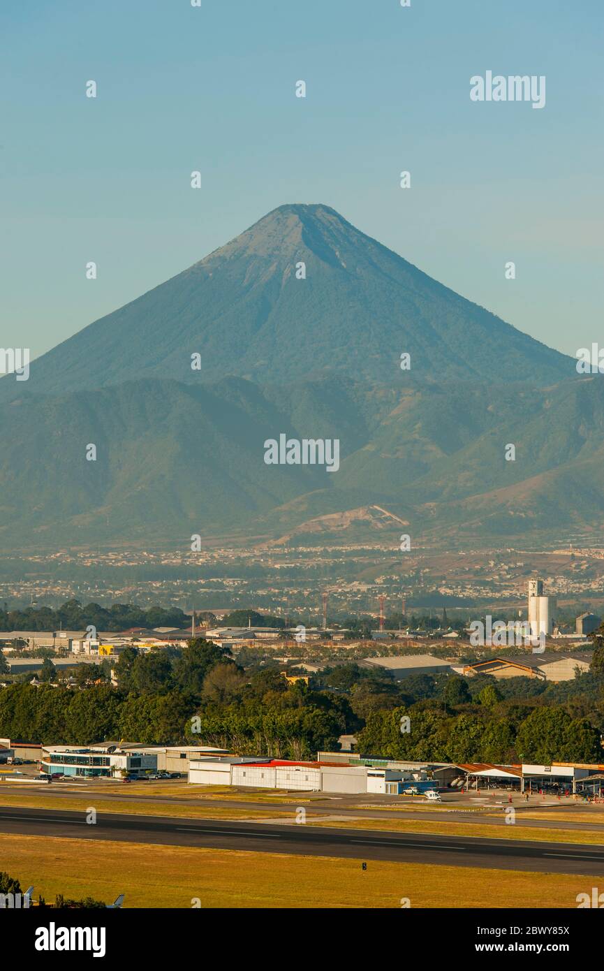 View of La Aurora International Airport in Guatemala City in Guatemala with the Agua volcano in the background. Stock Photo