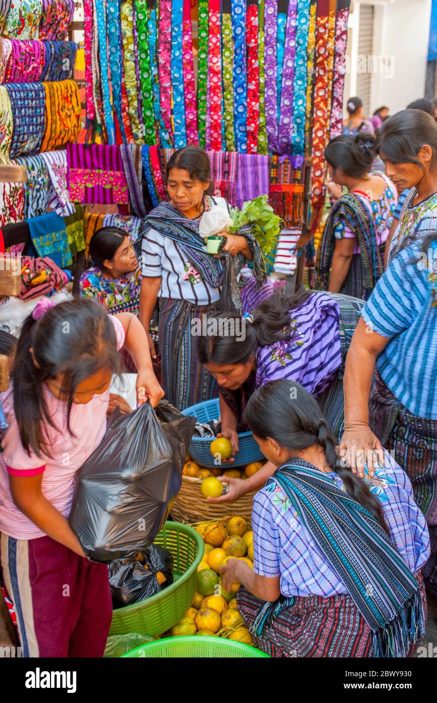 A colorful street market scene with people in the town of Santiago on Lake Atitlan in the southwestern highlands of Guatemala. Stock Photo