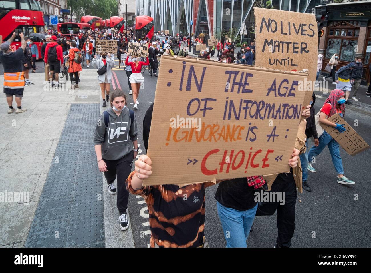 London, UK: June 3, 2020: Black Lives Matter protesters with signs walking from Westminster past Victoria Station Stock Photo