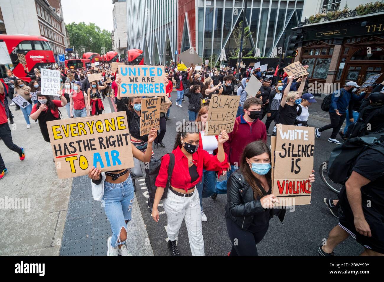 London, UK: June 3, 2020: Black Lives Matter protesters with signs walking from Westminster past Victoria Station Stock Photo