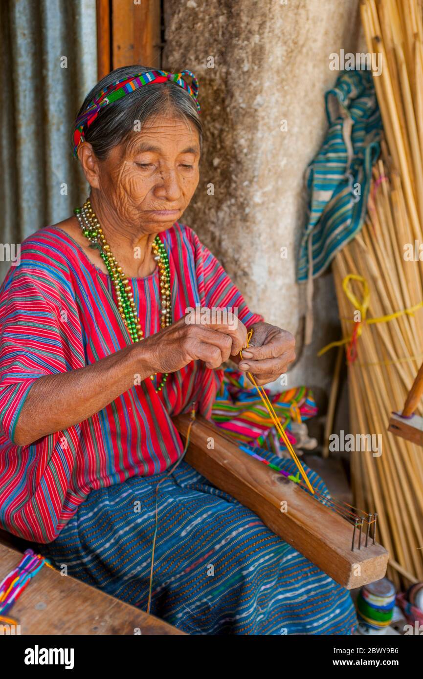 An old Mayan woman is making a bracelet in the town of San Antonio on Lake  Atitlan in the southwestern highlands of Guatemala Stock Photo - Alamy