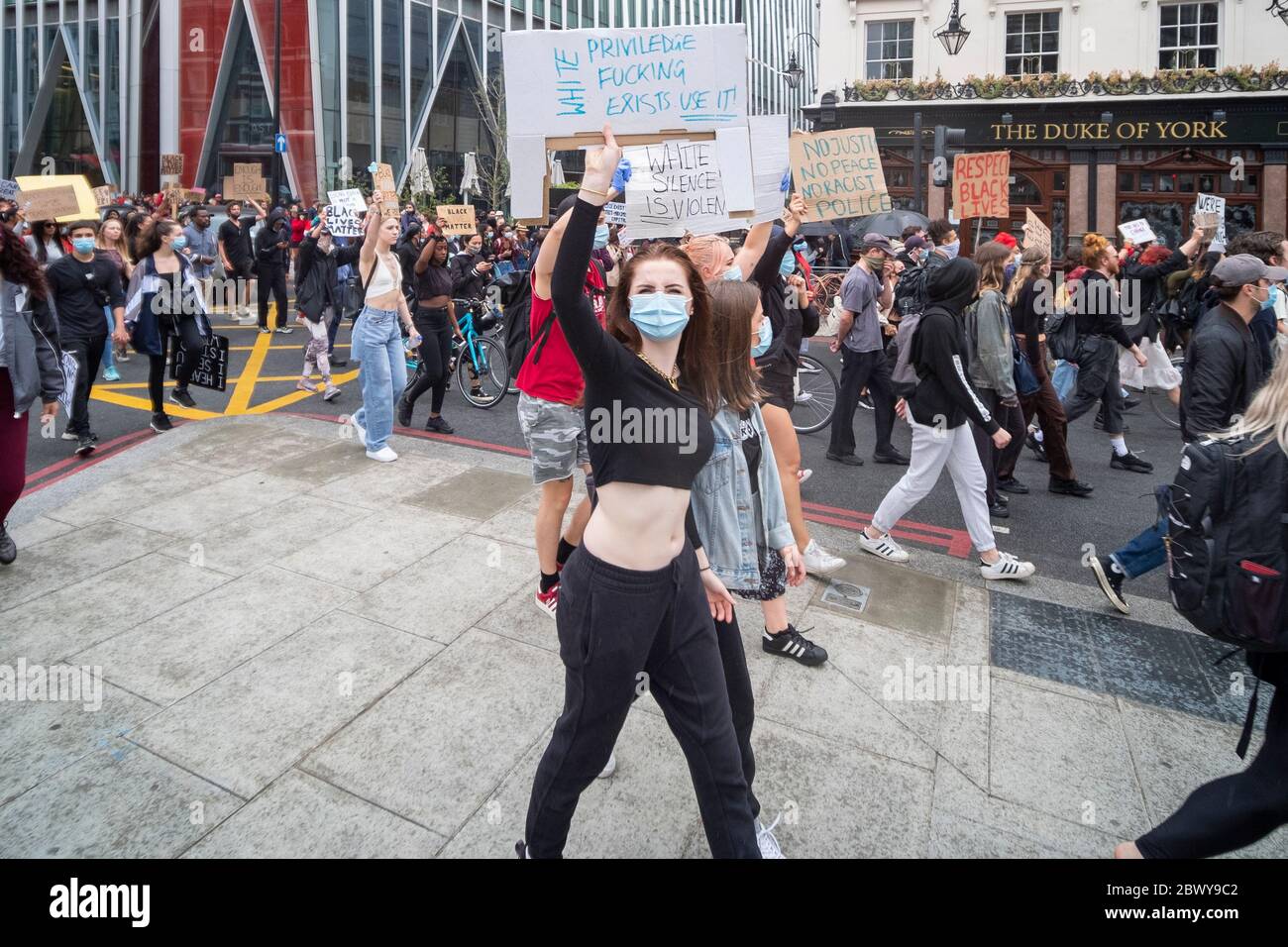London, UK: June 3, 2020: Black Lives Matter protesters with signs walking from Westminster past Victoria Station Stock Photo