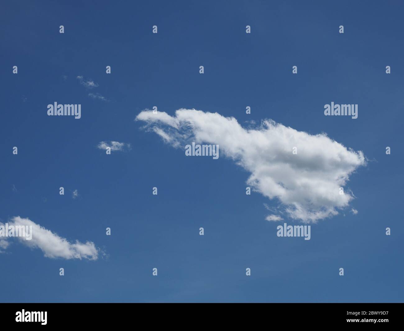 blue sky with cumulus clouds useful as a background Stock Photo - Alamy