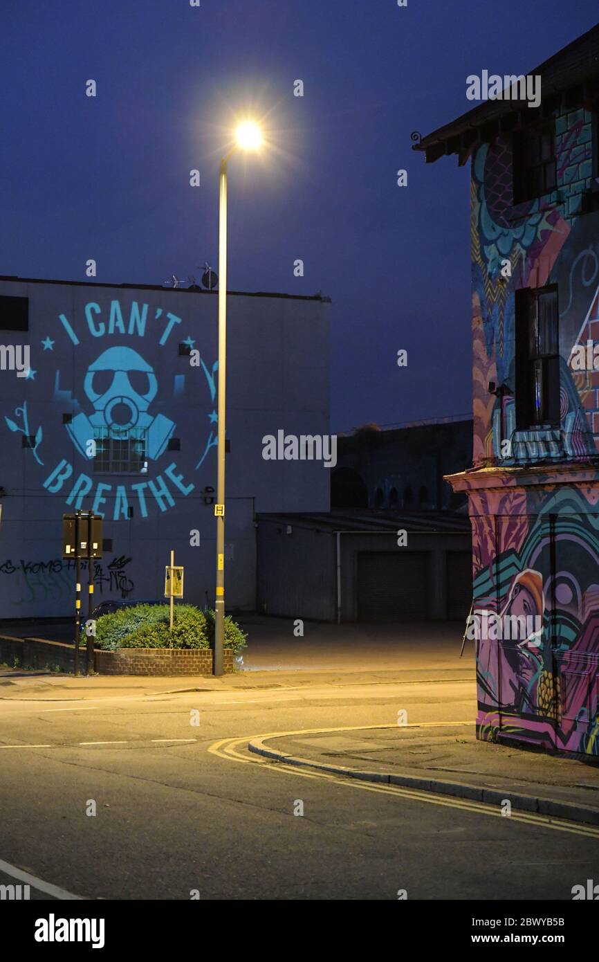 Birmingham, West Midlands, June 3rd 2020. George Floyd 'I Can't Breathe' statement artwork designed by Birmingham artist, Mohammed Ali Aerosol is projected on to the side of a Birmingham building in the Digbeth area of the city. David Whittall, who owns Suki10c, a pub opposite the artwork which is painted with 22 black stars of future of Birmingham. His pubs graffiti artwork is by Gent48. Whittall asked for permission to project the Floyd artwork. David said: 'We in the UK do not have to suffer the experience of a military-backed curfew enforced by baton, tear-gas, flash grenades and the viole Stock Photo