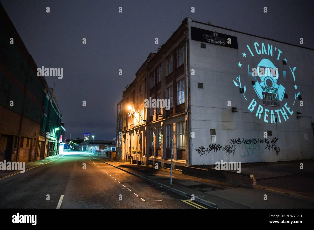 Birmingham, West Midlands, June 3rd 2020. George Floyd 'I Can't Breathe' statement artwork designed by Birmingham artist, Mohammed Ali Aerosol is projected on to the side of a Birmingham building in the Digbeth area of the city. David Whittall, who owns Suki10c, a pub opposite the artwork which is painted with 22 black stars of future of Birmingham. His pubs graffiti artwork is by Gent48. Whittall asked for permission to project the Floyd artwork. David said: 'We in the UK do not have to suffer the experience of a military-backed curfew enforced by baton, tear-gas, flash grenades and the viole Stock Photo