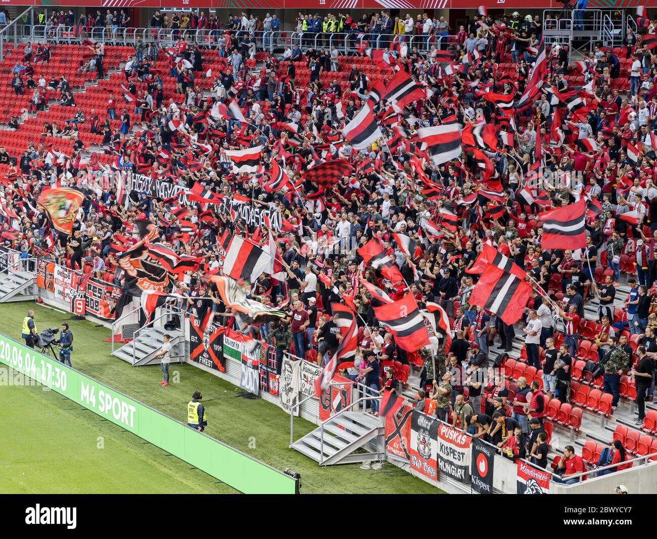 BUDAPEST, HUNGARY - JUNE 3: Ultras of Budapest Honved (as known as Puskas Army) flutter flags during the Hungarian Cup Final match between Budapest Honved and Mezokovesd Zsory FC at Puskas Arena on June 3, 2020 in Budapest, Hungary. Stock Photo