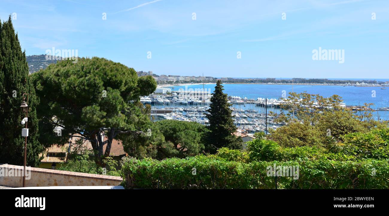 The city of Cannes in France, the famous Promenade de la Croisette and marina with yachts Stock Photo
