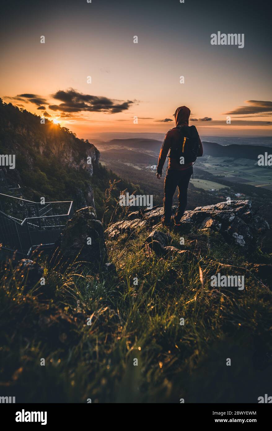 Man on top of mountain during Sunset in Summer Stock Photo - Alamy