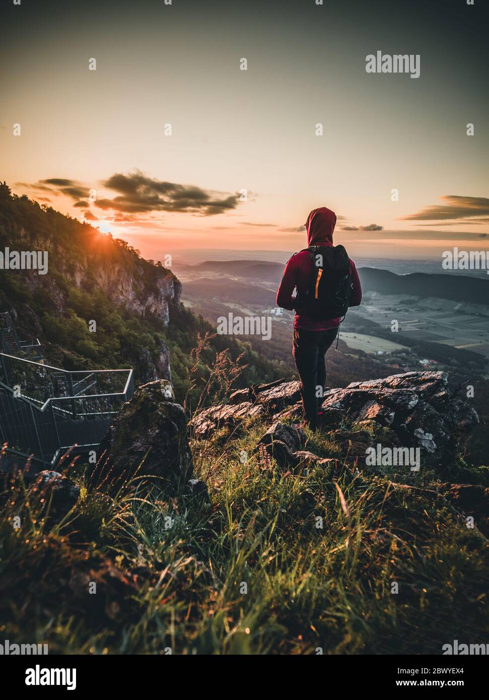 Man on top of mountain during Sunset in Summer Stock Photo - Alamy