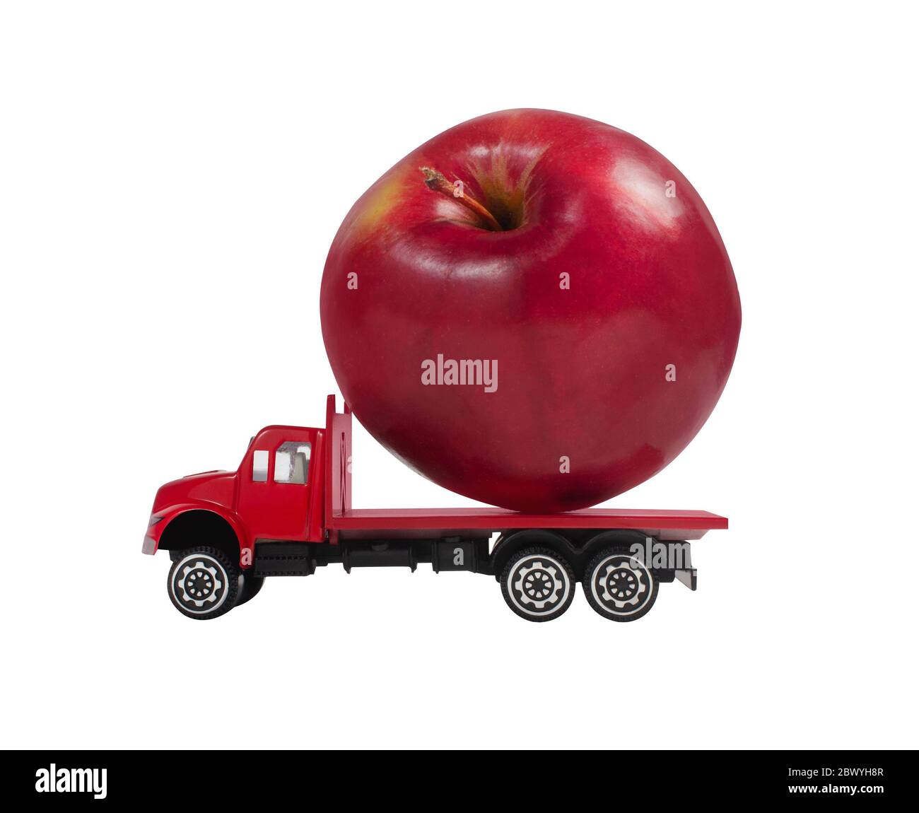 Isolated photo of a toy truck with apple cargo on white background profile view. Stock Photo