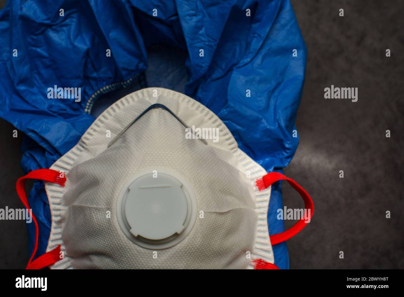 Blue medical suit with protective mask or respirator. Anti coronavirus and virus concept. Stock Photo