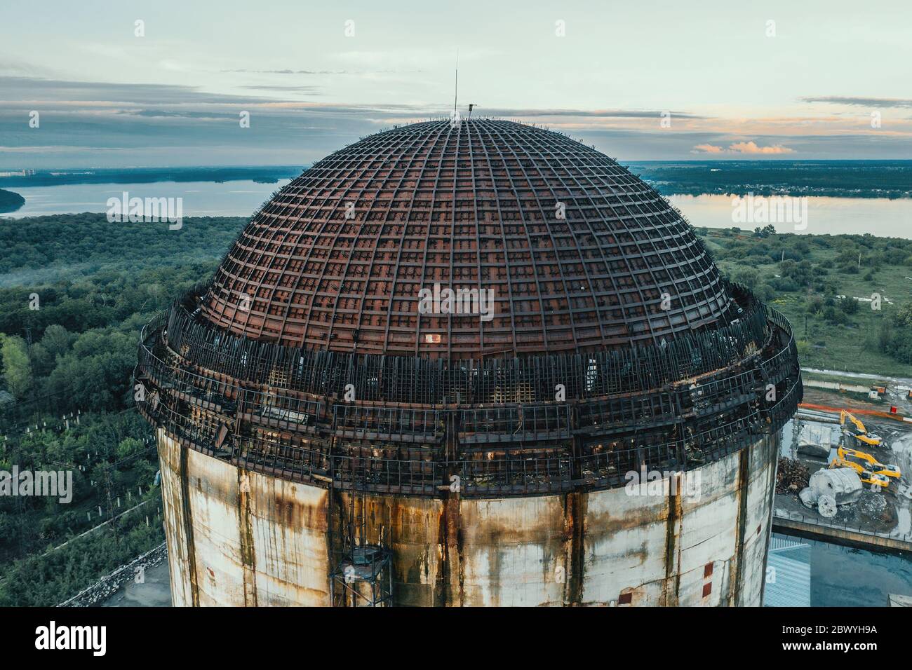 Unfinished nuclear power plant, circle metal construction dome roof, industrial building, aerial top view. Stock Photo