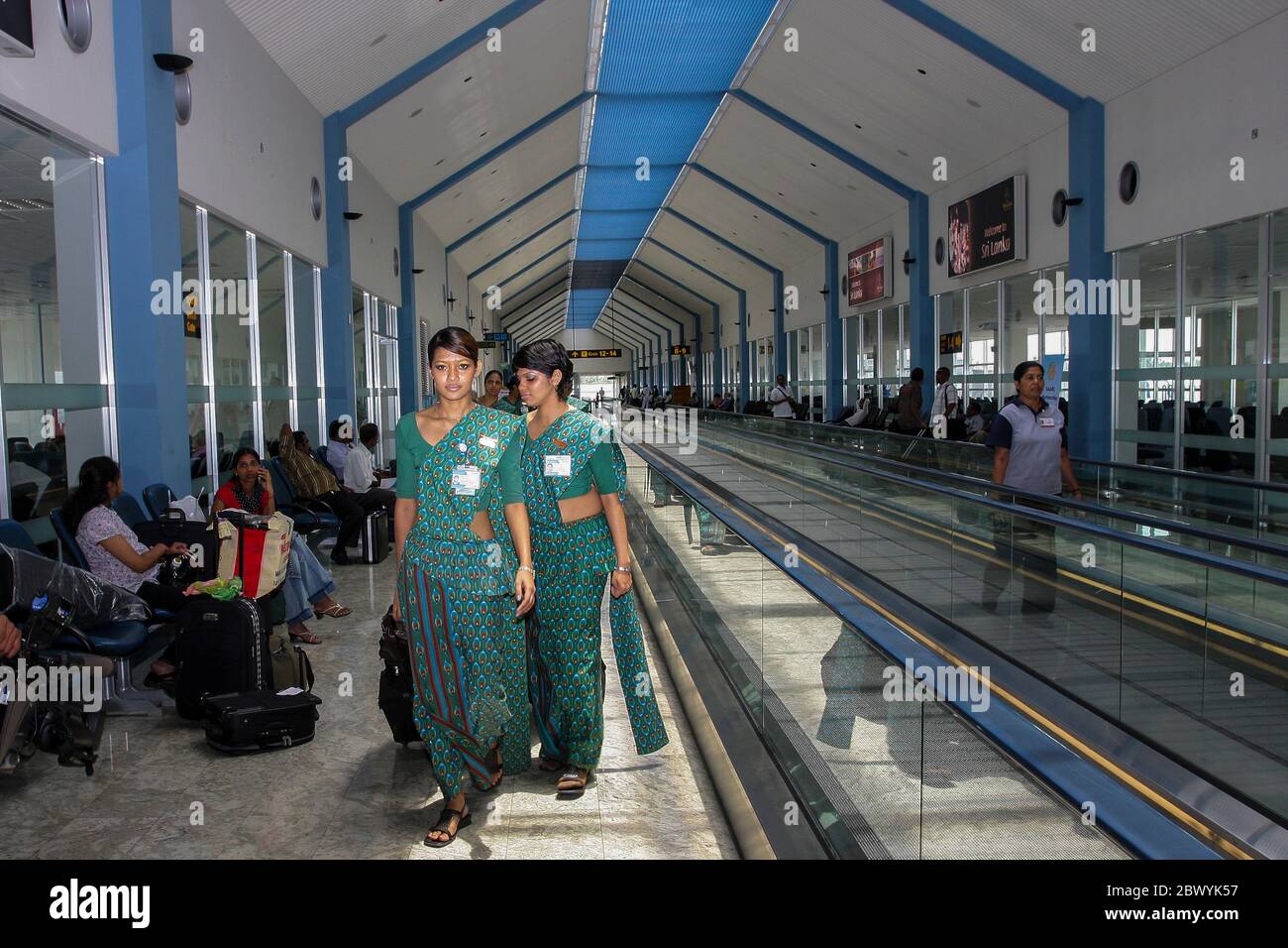 Young air hostess of Sri Lankan Airlines with luggage bag at the departure hall of Bandaranaike International Airport. Sri Lanka. Stock Photo