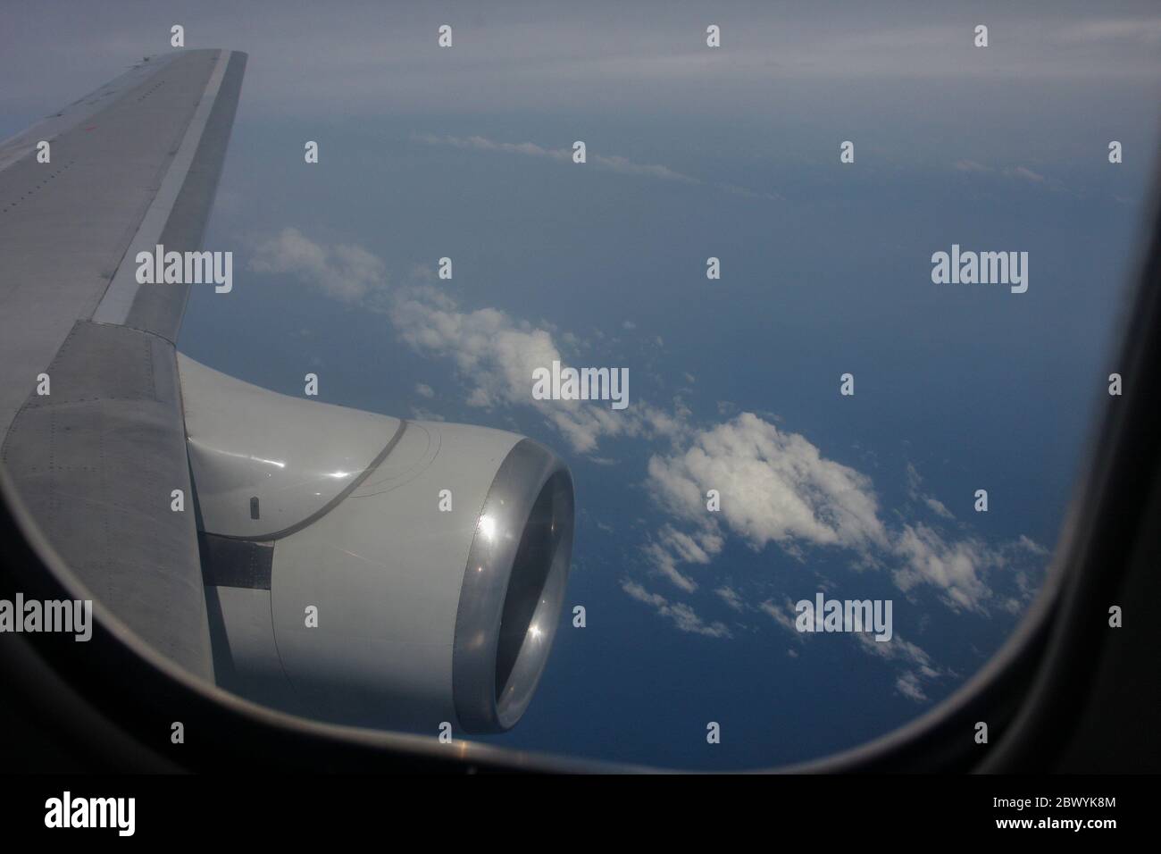 Aircraft engine viewed from the window of a Boeing 737-200 aircraft flying above 33000 feet. Stock Photo