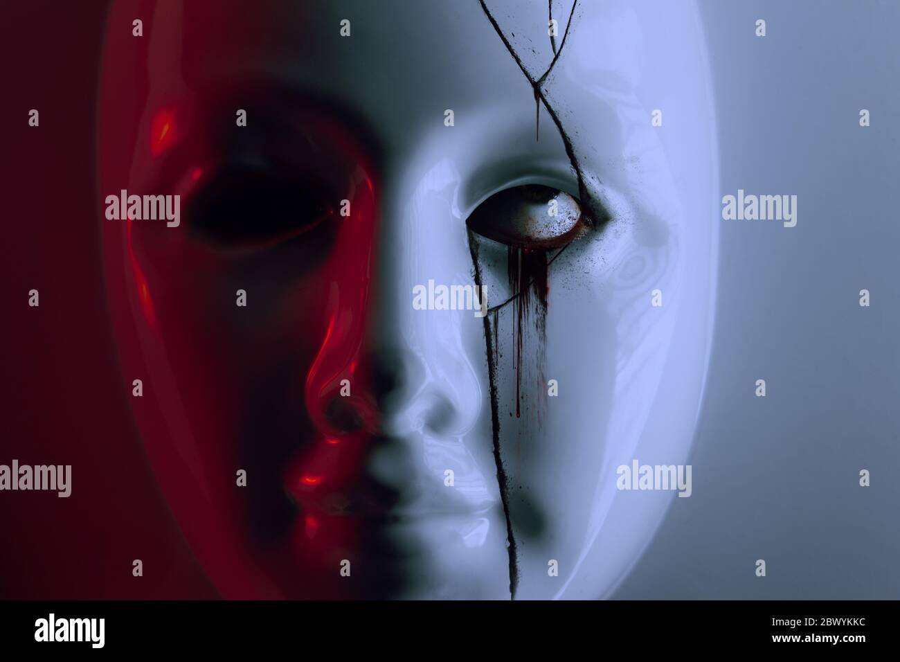 Horror photo of a scary broken plastic mask with bleeding eye under it