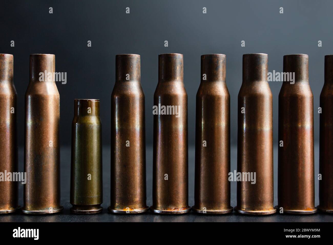 Concept photo of automatic rifle gun shells standing in line with one