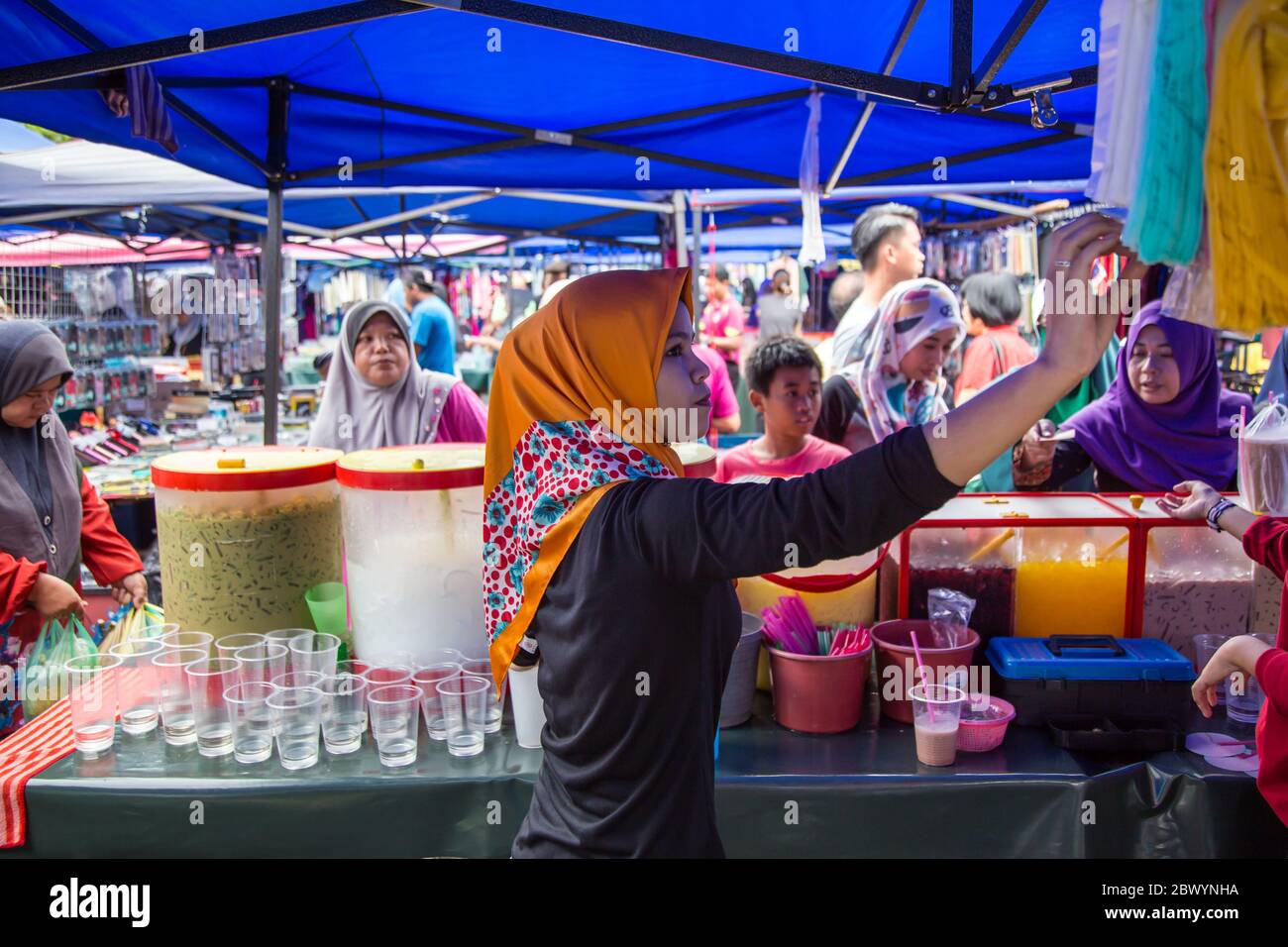 Tuaran, Sabah, Malaysia-January 21,2018: Local Young Malaysian Muslim lady selling drink at the weekly market at Tuaran, Sabah, Malaysia Stock Photo