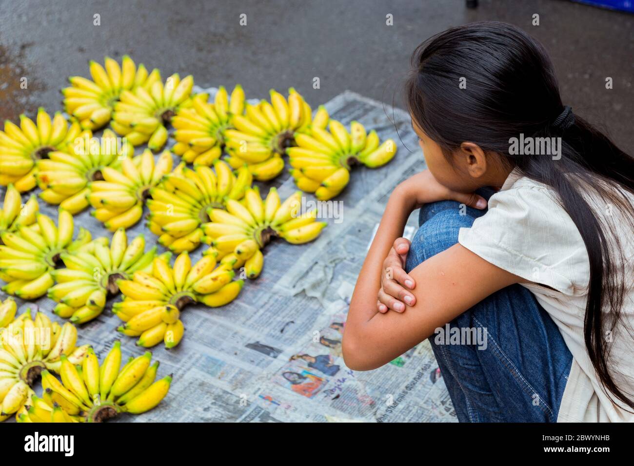 Tuaran, Sabah, Malaysia-January 21,2018: Unidentified young lady sales fresh banana sold in Tamu or weekly market at Tuaran Sabah, Malaysia Stock Photo