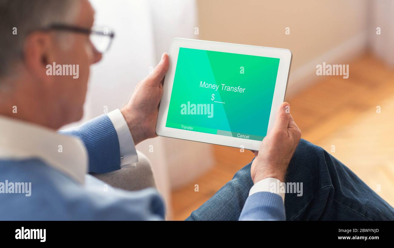 Easy Money Transfers. Elderly Man Using Digital Tablet With App For E-Banking Stock Photo