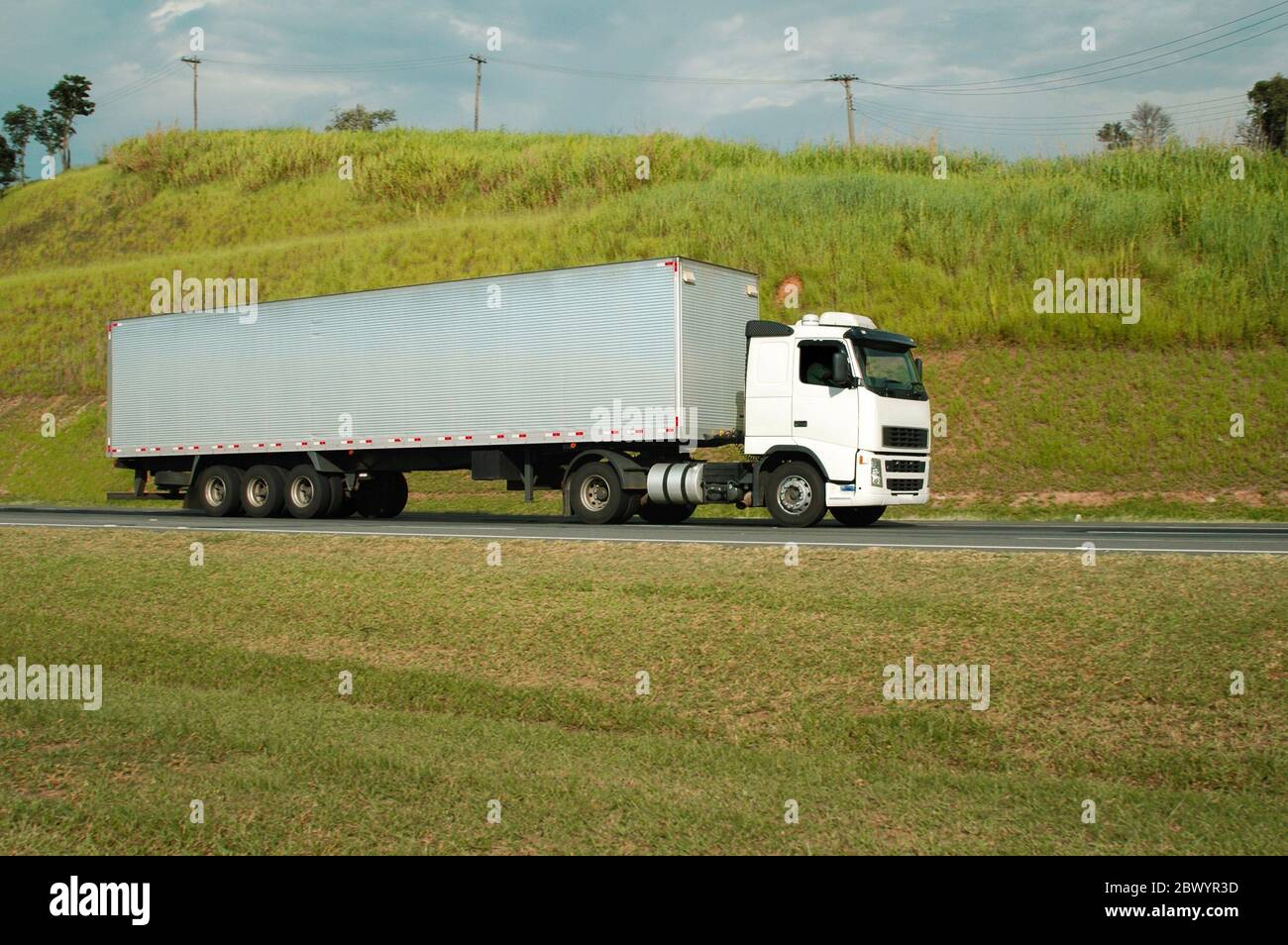 white semi trck with long silver trunk Stock Photo - Alamy