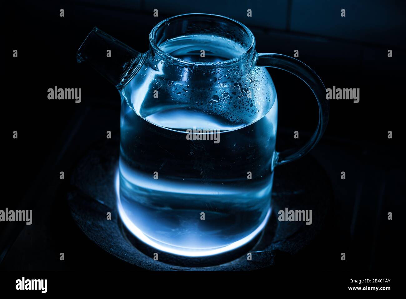 boiling water in glass teapot on a gas stove Stock Photo Alamy