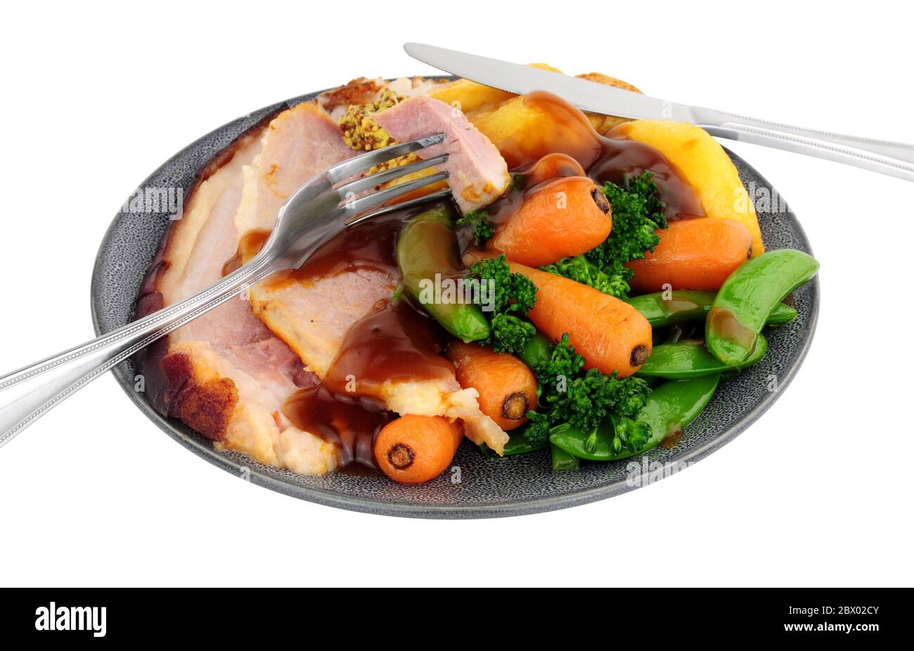 Roast gammon and vegetable meal isolated on a white background Stock