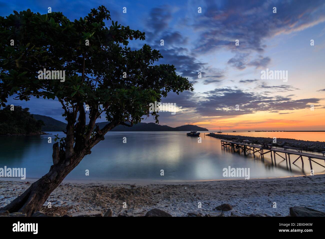 Amazing Beautiful Sunset and dramatic cloud with wooden jetty at Kuala Abai, Kota Belud, Sabah Stock Photo