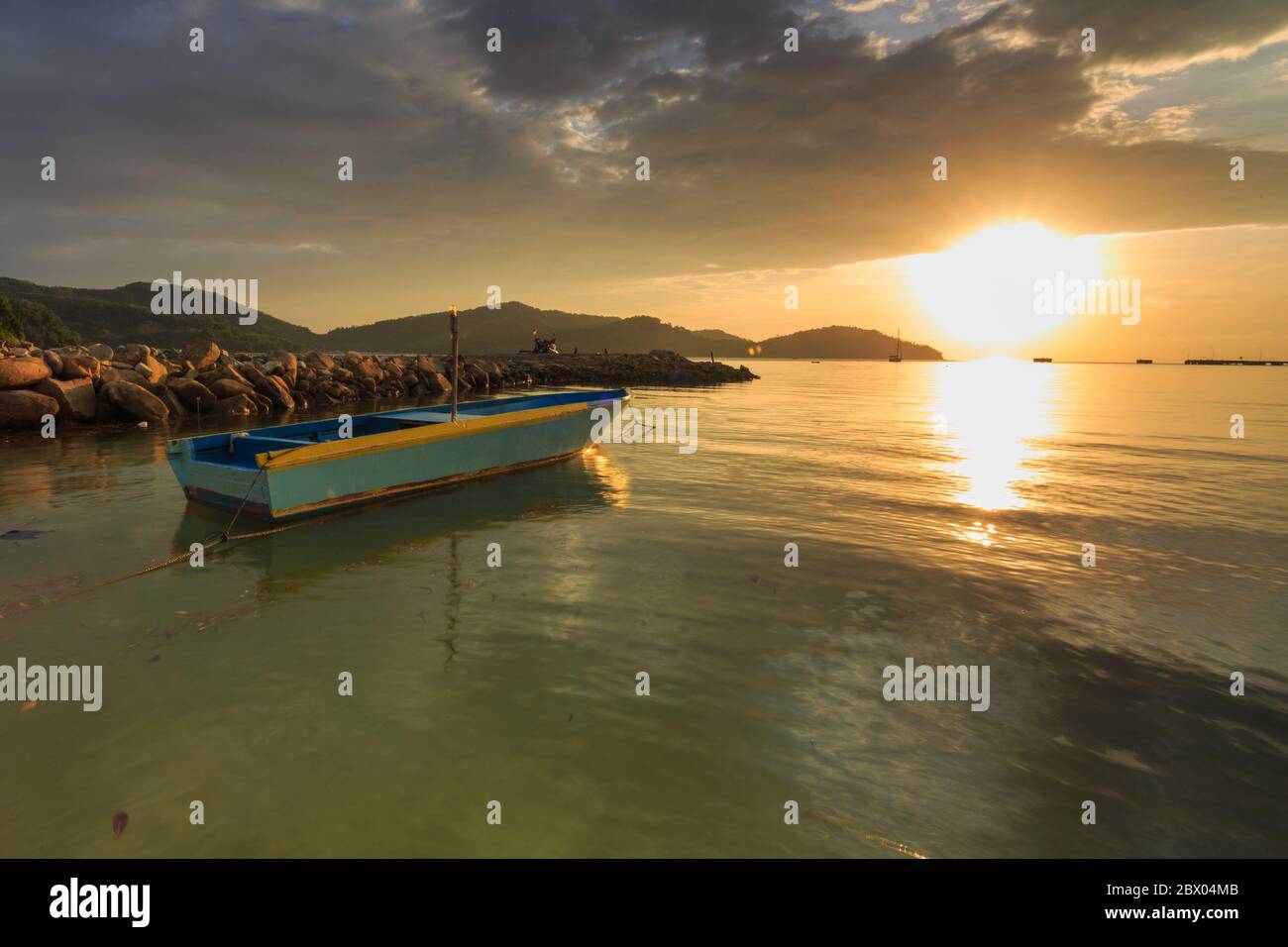 Amazing Beautiful Sunset and dramatic cloud with wooden jetty at Kuala Abai, Kota Belud, Sabah Stock Photo