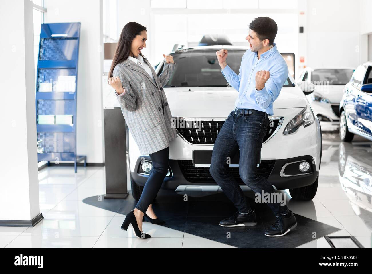 Joyful Family Couple Celebrating Buying Brand New Auto Stock Photo