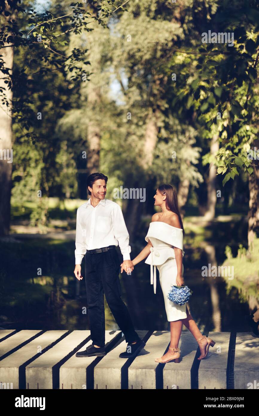 Wedding Couple Walking Holding Hands In Park, Vertical Shot Stock Photo ...