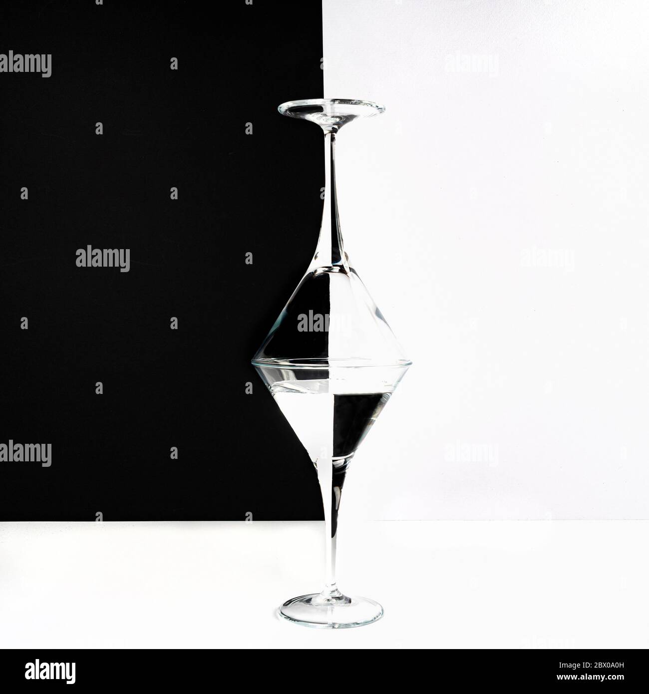 two glasses superimposed on a white surface and a two-tone background Stock Photo