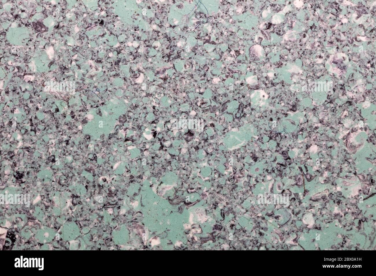 Grainy light green plastic surface. Top view. Close-up shot. Abstract idea. Stock Photo