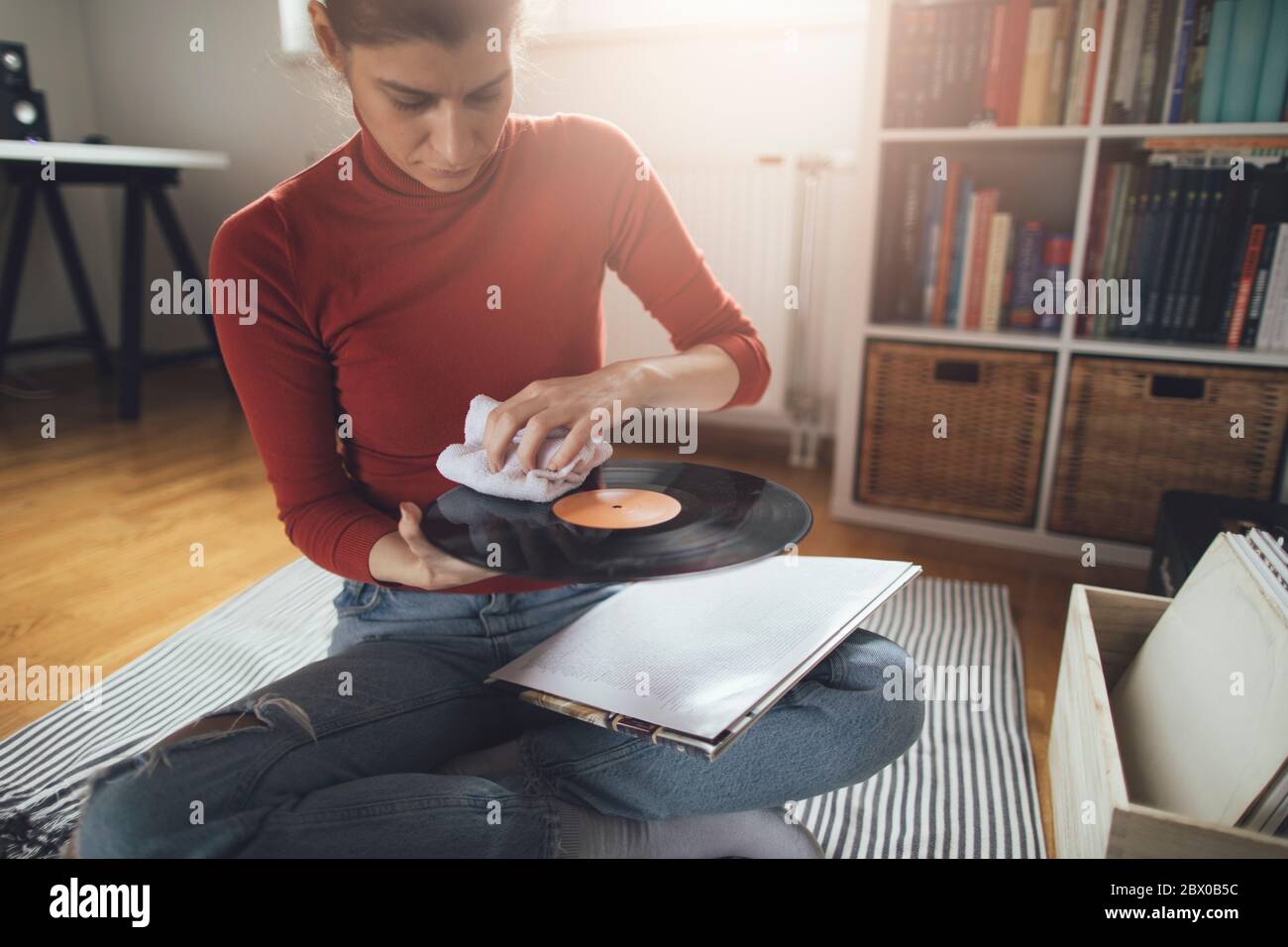 Young audiophile cleaning dust form vinyl record Stock Photo Alamy