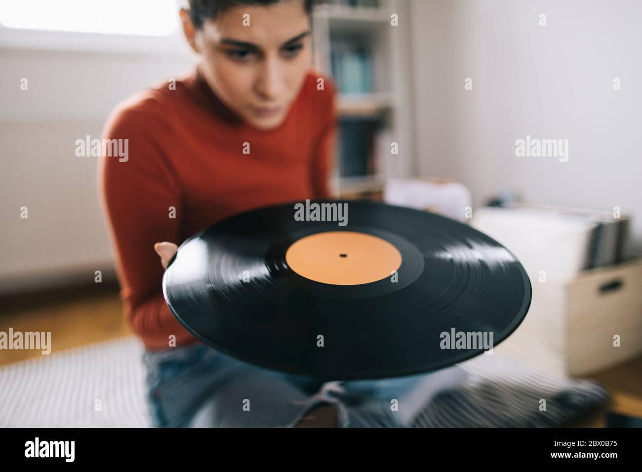 Young audiophile cleaning dust form vinyl record Stock Photo Alamy