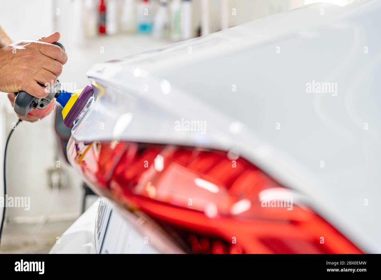 manual polishing of the body of luxury cars with the application of ceramic protective equipment Stock Photo
