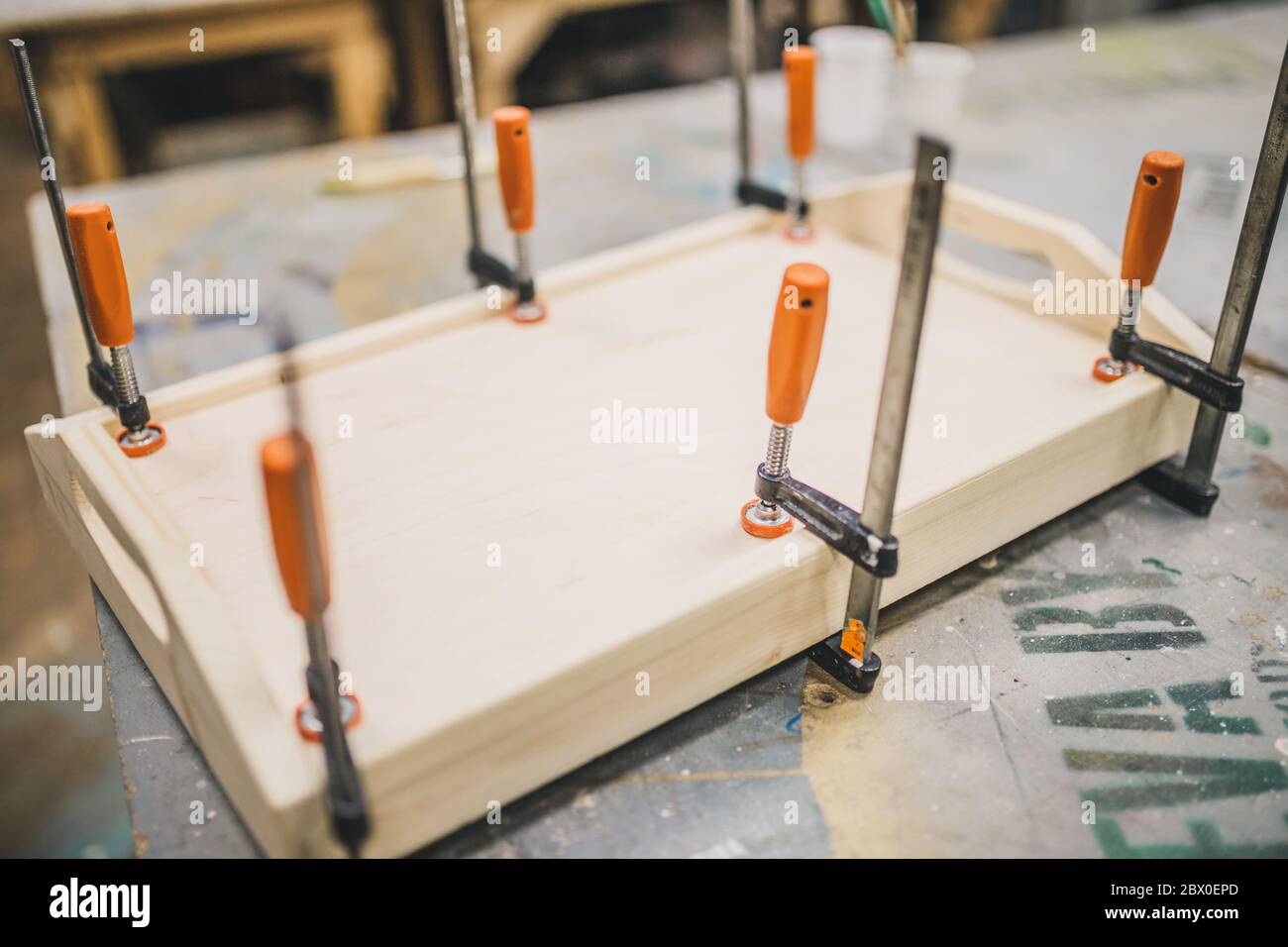 A rectangular tray in a carpentry workshop fixed with clamps Stock Photo
