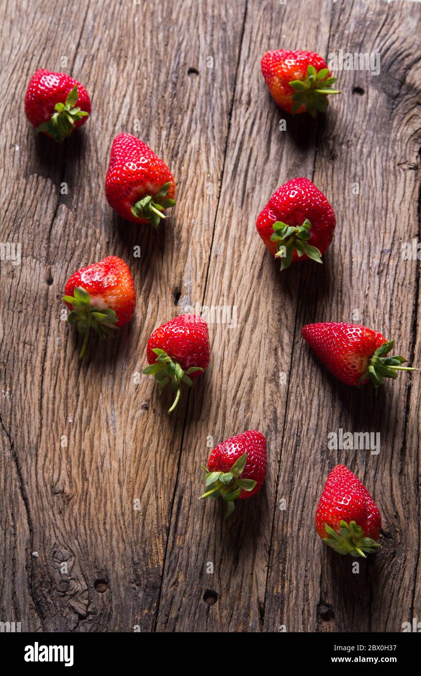 Fresh strawberries on old wooden background Stock Photo - Alamy