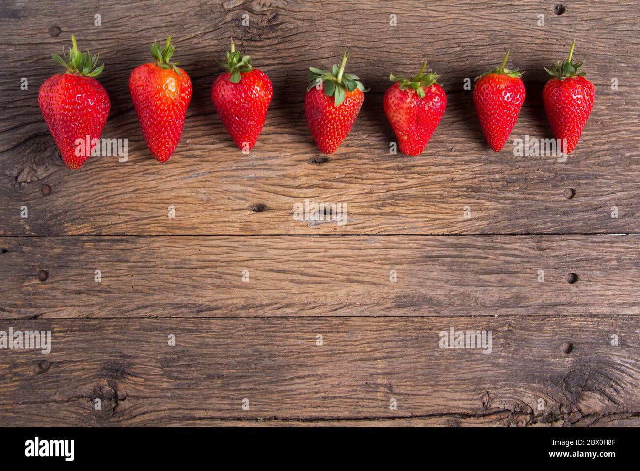 Fresh strawberries on old wooden background Stock Photo - Alamy